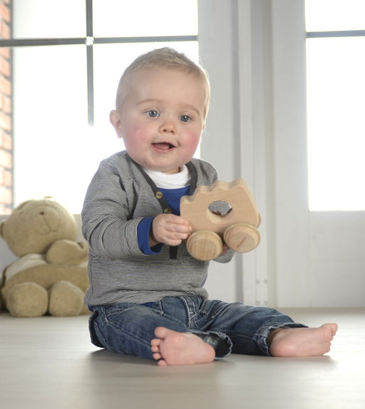 Baby playing with Wooden push along hedgehog