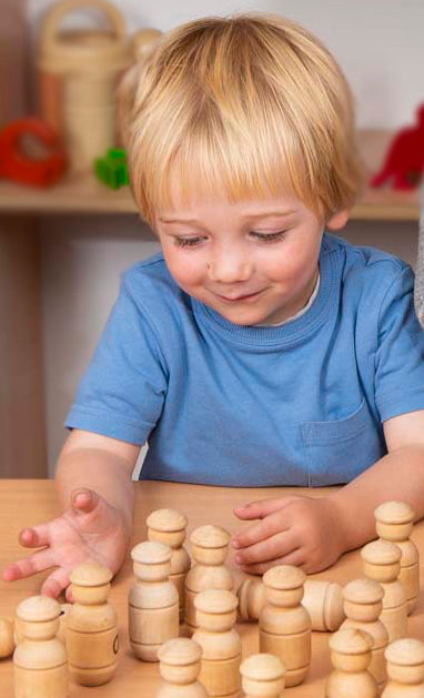 Child playing with alphabet wooden people