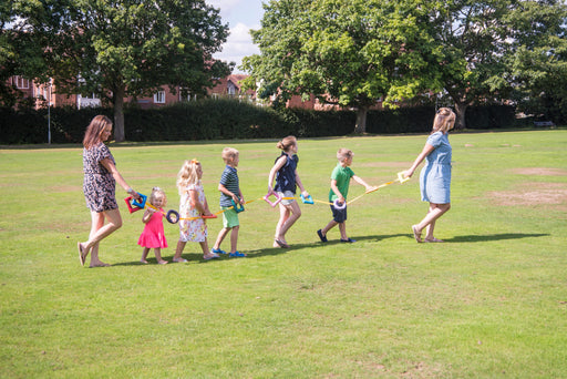 Children and teachers holding walking links