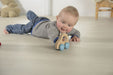 Baby playing with a Wooden push along car