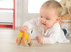 Baby playing with a push along lion