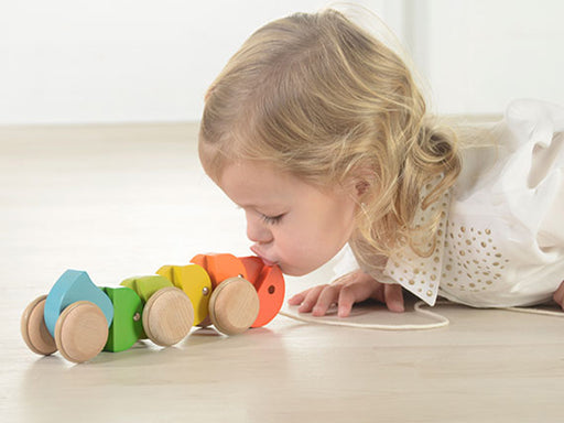 Child playing with push along caterpillar