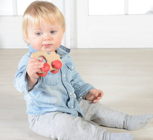 Baby playing with a Wooden grabbie train